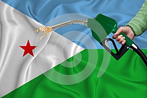 DJIBOUTI flag Close-up shot on waving background texture with Fuel pump nozzle in hand. The concept of design solutions. 3d