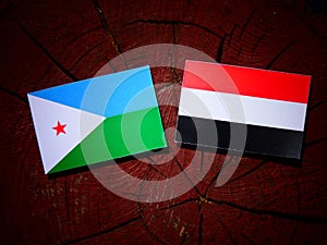 Djibouti flag with Yemeni flag on a tree stump