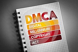 DMCA - Digital Millennium Copyright Act acronym on notepad, technology concept background