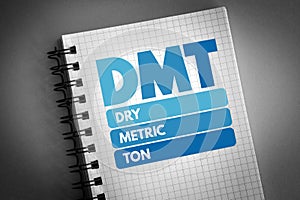 DMT - Dry Metric Ton acronym on notepad, business concept background