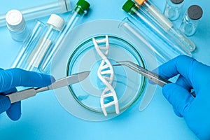 DNA helix research. Concept of genetic experiments on human biological code. Medical instrument scalpel and forceps and test tubes