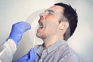 DNA test. Doctor Doing Coronavirus covid 19 Test For male Patient. Taking a saliva sample from a man. Collection of