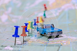 Dnepr, Ukraine - January  17, 2018: The toy retro cabriolet is on the geographical map of the world. The concept of travel.