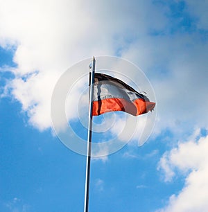 DNR flag on a background of blue sky. A disheveled flag