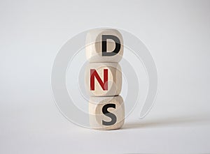 DNS -Domain Name Server - Consumer Price Index symbol. Concept word DNS on wooden cubes. Beautiful white background. Business and