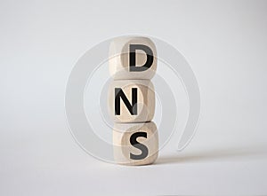 DNS -Domain Name Server - Consumer Price Index symbol. Concept word DNS on wooden cubes. Beautiful white background. Business and