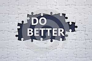 Do better symbol. White puzzle with words Do better. Beautiful dark blue background. Business and Do better concept. Copy space