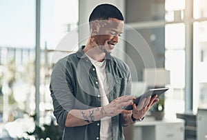 Do the common thing uncommonly well. a young business man using a tablet at work.