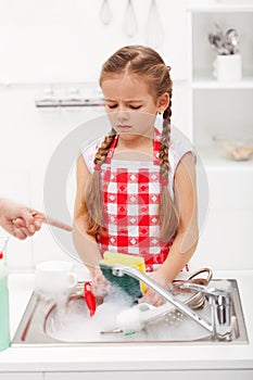 Do the dishes this instant - child ordered to wash up tableware