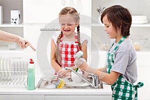 Do the dishes - kids ordered to help in the kitchen photo