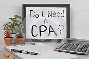 Do I Need a CPA sign handwritten on white poster framed in gray picture frame