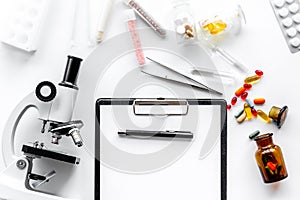 Do medcal tests. Microscope, tablet, pills and test tube on white background top view