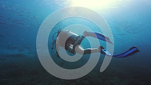 Do more things that make you feel alive. 4k video footage of an unrecognizable man scuba diving alone in the depths of