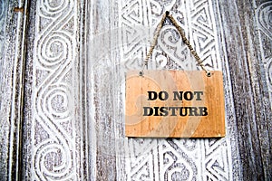 Do not disturb board on wooden white decorative door