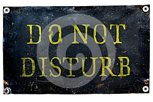 DO NOT DISTURB old shabby black metal plate with yellow letters