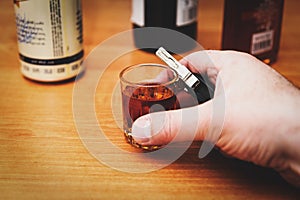 Do not drink and drive. Drunk man hand with glass alcohol,car key in hand taking car keys
