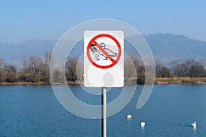 Do not feed the ducks sign near lake