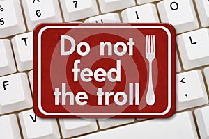 Do not feed the troll sign on a keyboard