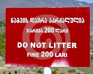 A DO NOT LITTER sign outside of the sunny Gelati Monastery in rural Georgia