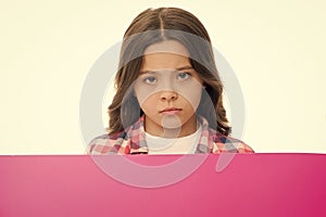 Do not offend children. Girl kid behind pink blank surface copy space. Advertisement concept. Child cute girl looking