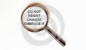 Do Not Resist Change Embrace It on a sheet under a magnifying glass