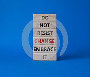 Do not resist change embrace it symbol. Concept words Do not resist change embrace it on wooden blocks. Beautiful blue background photo