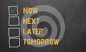 Do it now - business concept on blackboard
