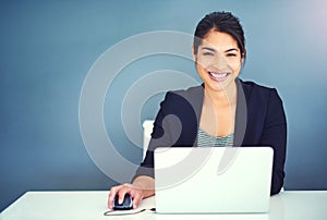 Do it with passion or not at all. a young businesswoman working at her desk.