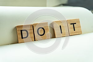 Do it print wording on wood block. on white notebook and office equipment.