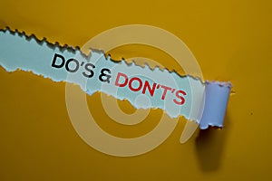 Do`s & Don`t`s Text written in torn paper