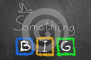 Do something big chalk text on blackboard or chalkboard