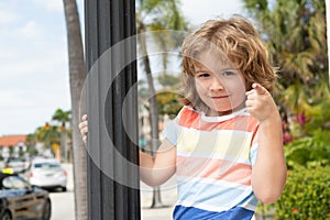 Do what makes you happy. Child smile pointing finger. Playful boy summer outdoors. Happy boyhood