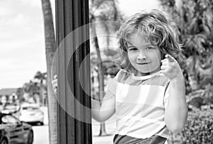 Do what makes you happy. Child smile pointing finger. Playful boy summer outdoors. Happy boyhood