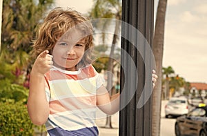 Do what makes you happy. Child smile pointing finger. Playful boy summer outdoors. Happy boyhood