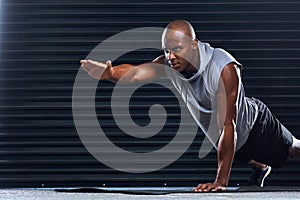 Do what needs to be done. a handsome young man doing push-ups.