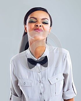 Do you like my nose. Cropped portrait of a trendy young woman making a face against a gray background.