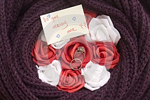 do you marry me? hand writing and flowers and alliance. photo