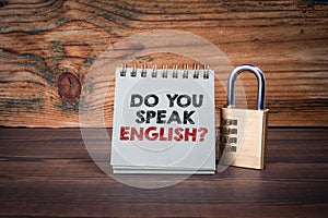 Do You Speak English. Cardboard notepad on wooden texture table