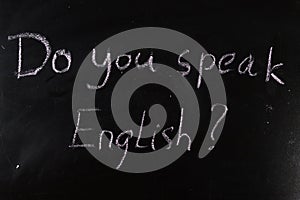 do you speak English question written with chalk on a blackboard