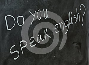 Do you speak English, written on a blackboard