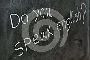 Do you speak English, written on a blackboard