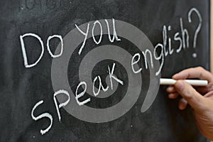 Do you speak English, written on a blackboard