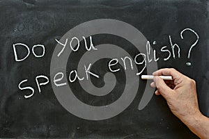 Do you speak English, written on a blackboard