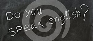 Do you speak English, written on a blackboard