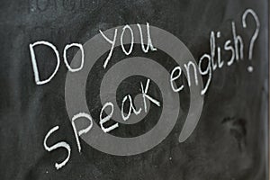 Do you speak English, written on a blackboard photo