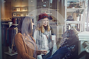 Do you think itll look good on me. two best friends out shopping in a clothing store.