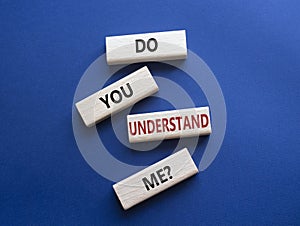 Do you understand me symbol. Concept words Do you understand me on wooden blocks. Beautiful deep blue background. Business and Do