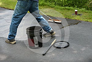 Maintaining an asphalt driveway with blacktop sealer photo