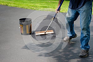 Spreading asphalt in home driveway photo