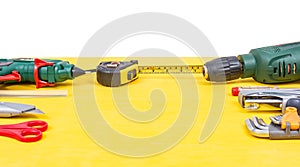 Do it yourself tools on yellow background. DIY tools with copy space for text on yellow wooden background. Different tools for han